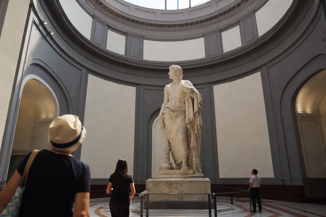 Early morning in the Accademia tribune with Michelangelo's David lit from above and only a handful of visitors present